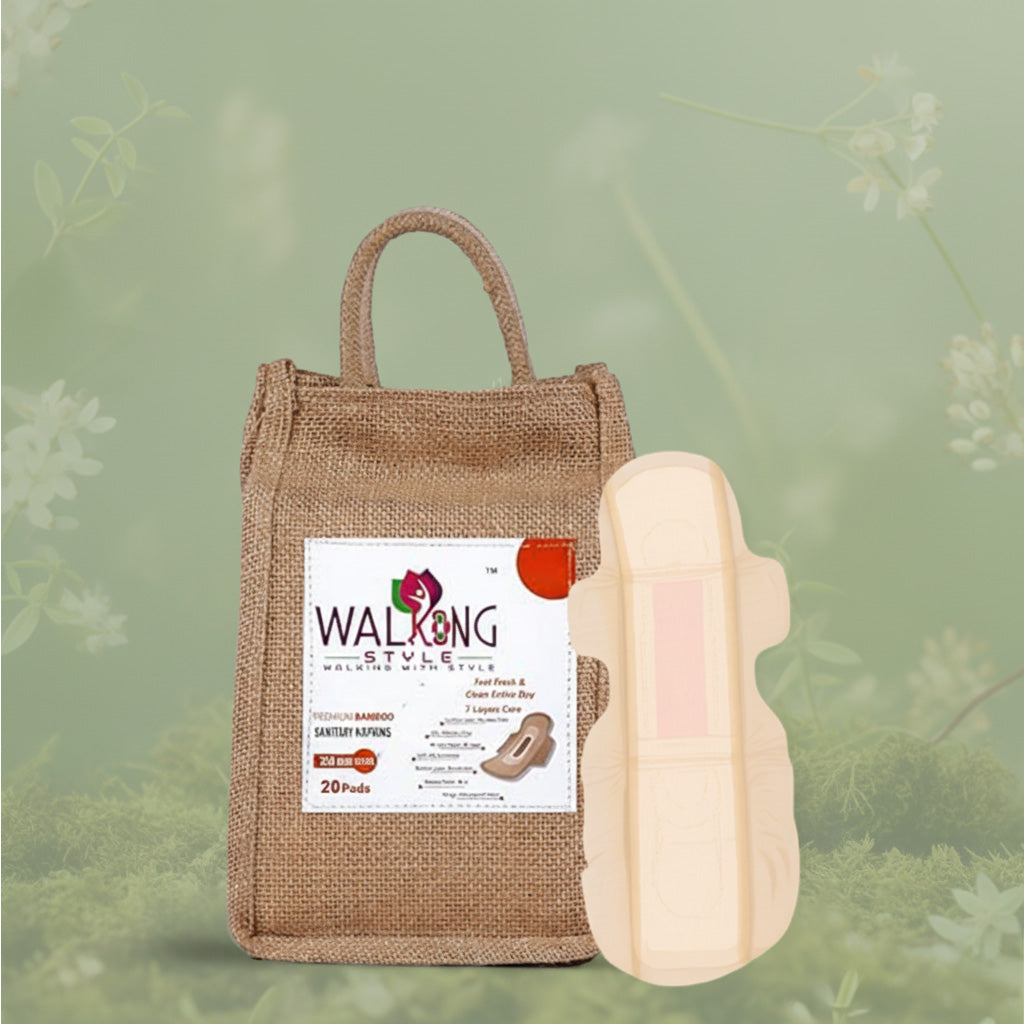 Burlap-wrapped pack of bamboo sanitary pads next to a small bamboo stalk, highlighting eco-friendly period care.